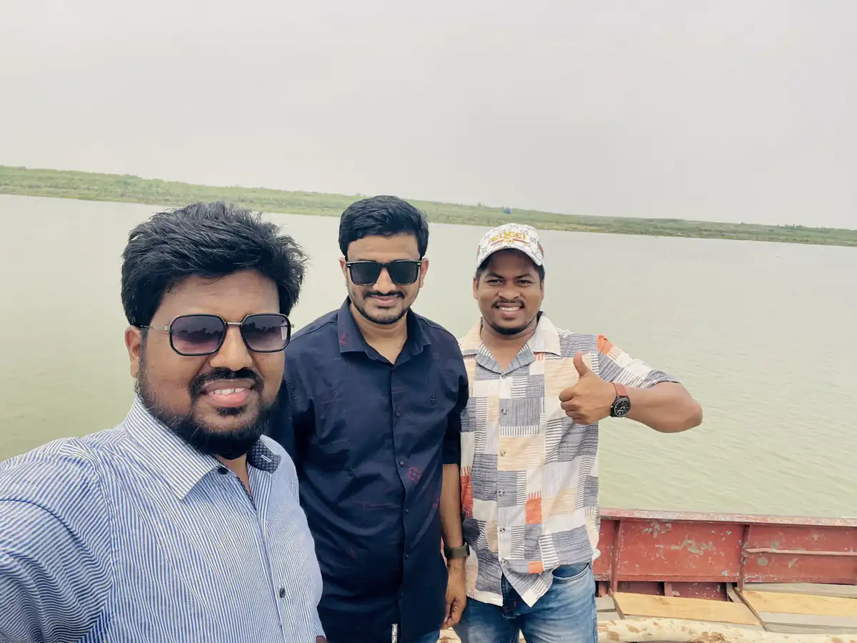 Abdul Mannan Zinnat taking a selfie with two friends on a boat