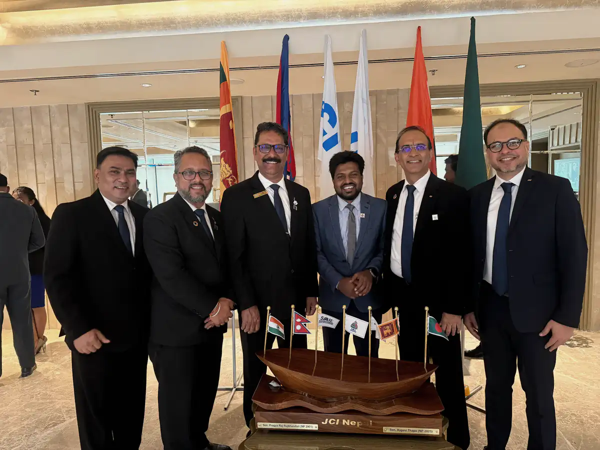 Abdul Mannan Zinnat with leadership instructors at SAAIL 2026 in Nepal, national flags behind them