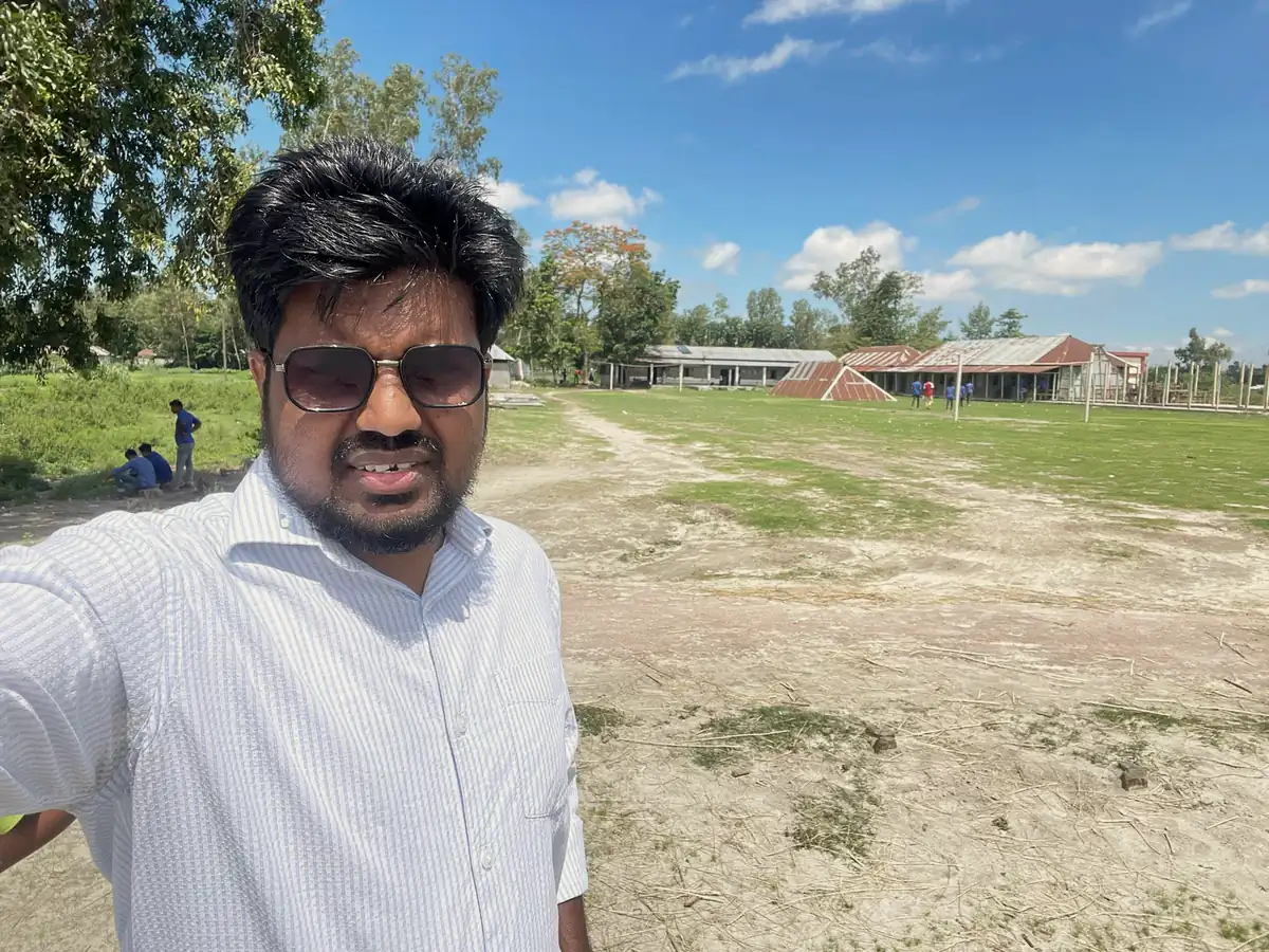 Abdul Mannan Zinnat taking a selfie on open land under a blue sky