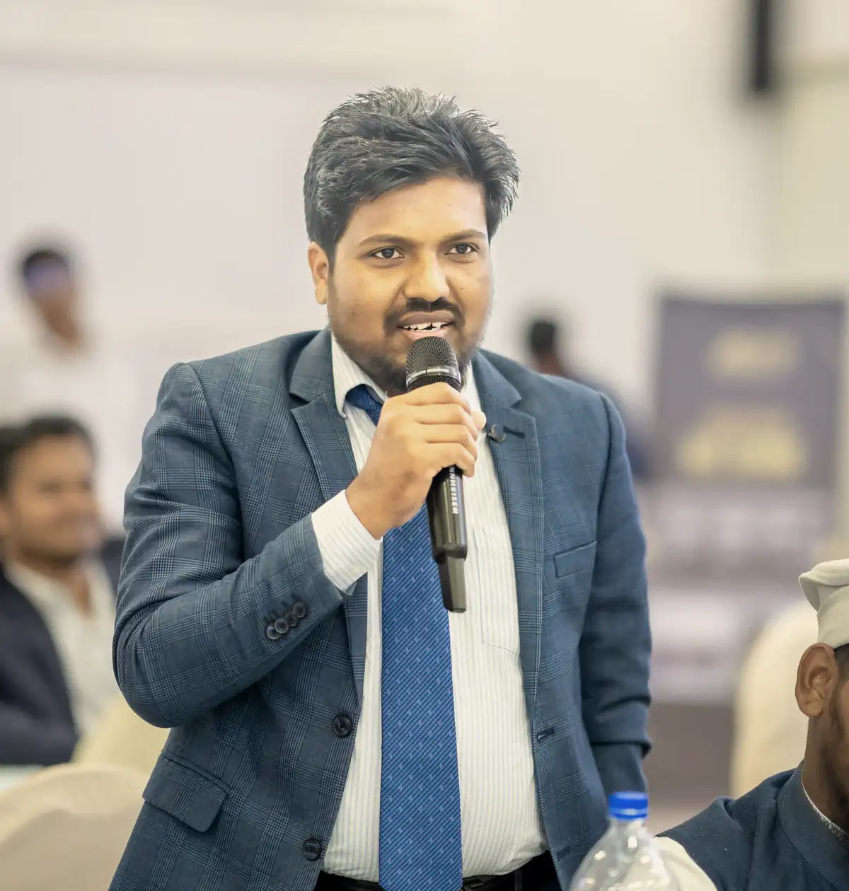 Abdul Mannan Zinnat speaking into a microphone at an event