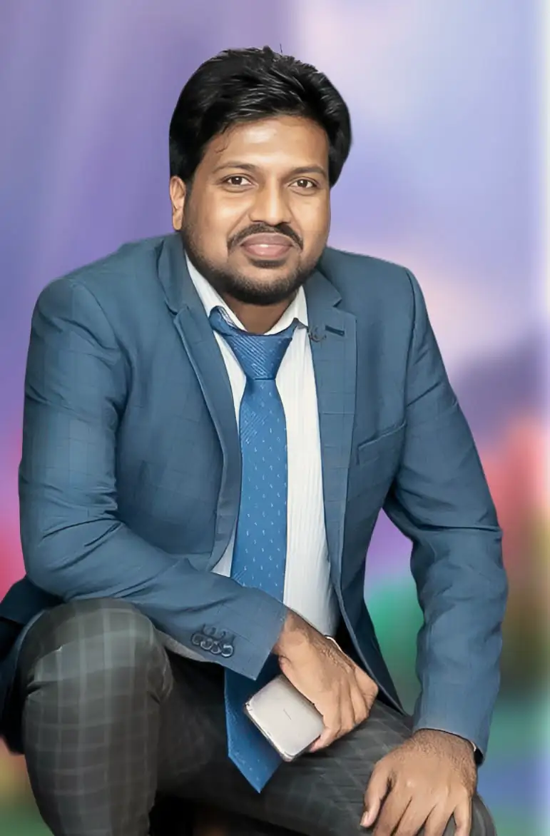 Abdul Mannan Zinnat kneeling for a studio portrait in a blue blazer