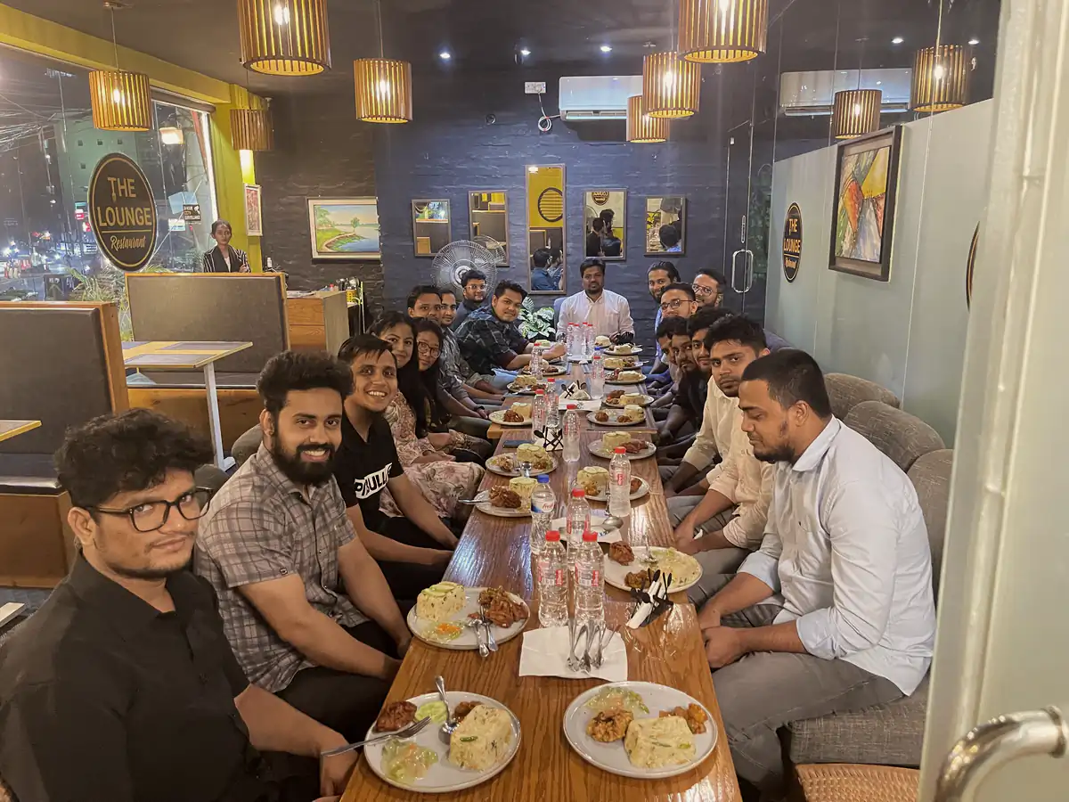 A long restaurant table with the team gathered for dinner